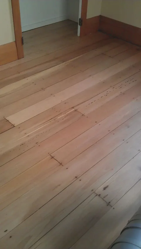 Freshly sanded pale timber boards, clean and ready for coating